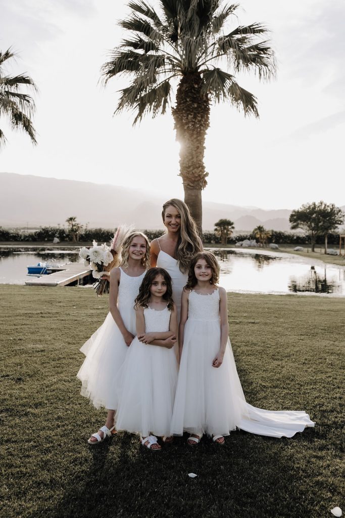 bride posing with flower girls in Coachella valley