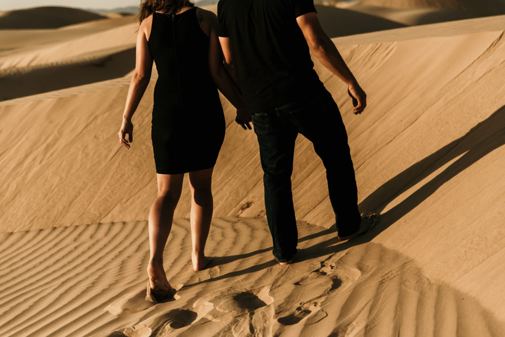 climbing the dunes during glamis engagement session
