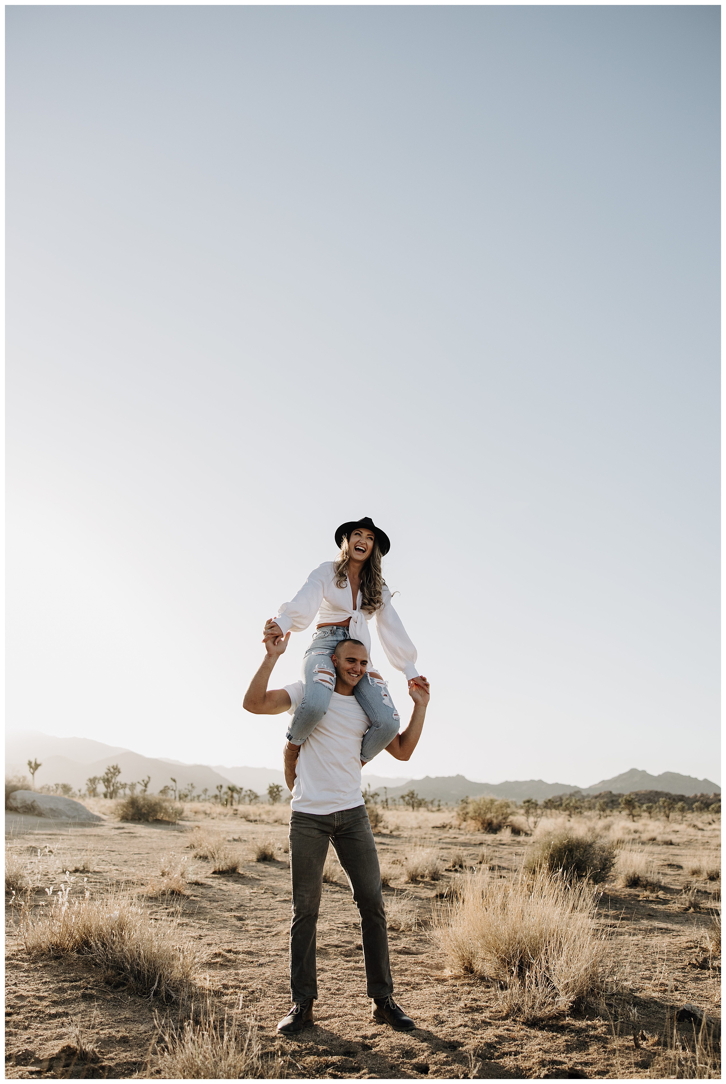 girl on fiance's shoulders at joshua tree
