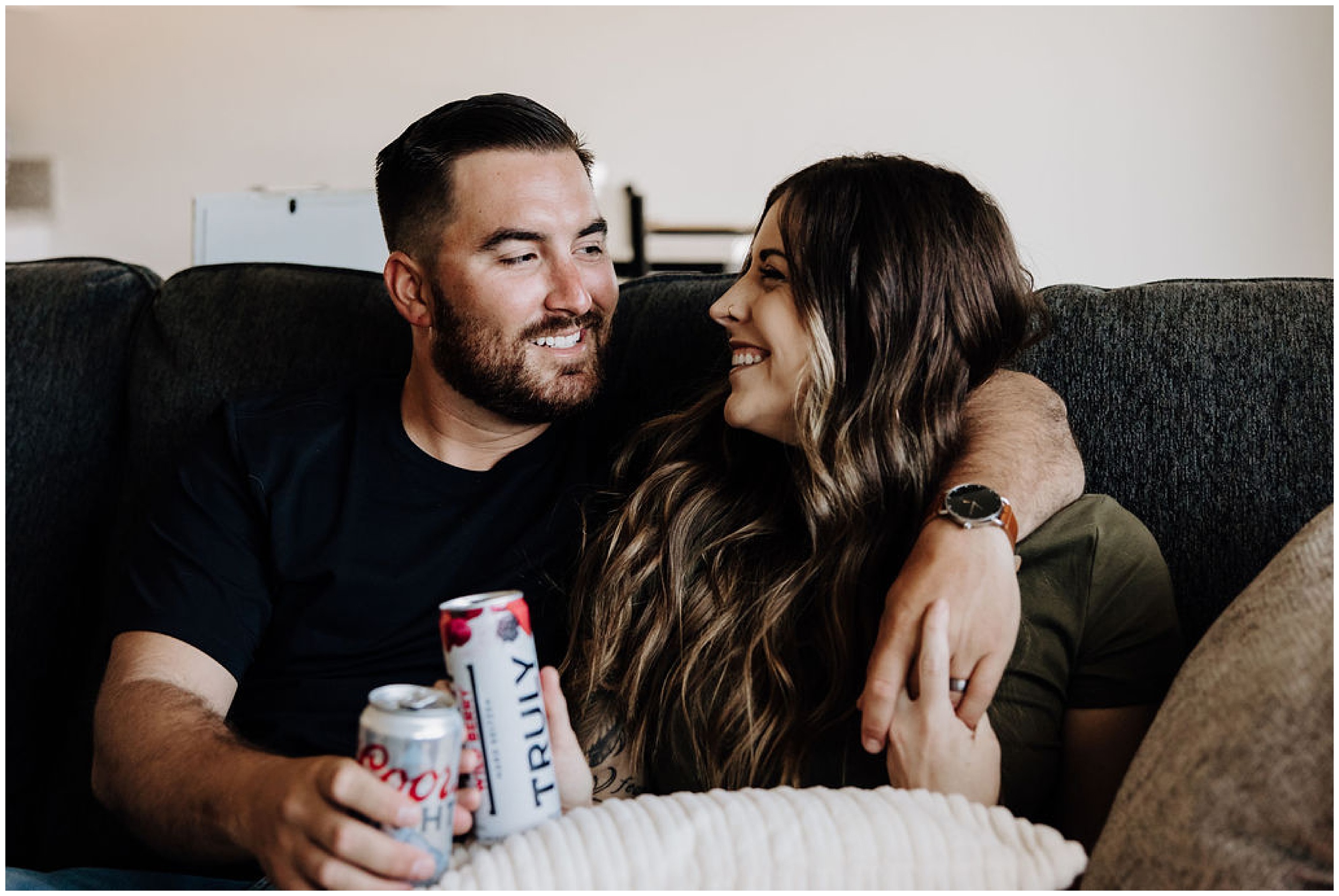 couple sitting on couch with drinks