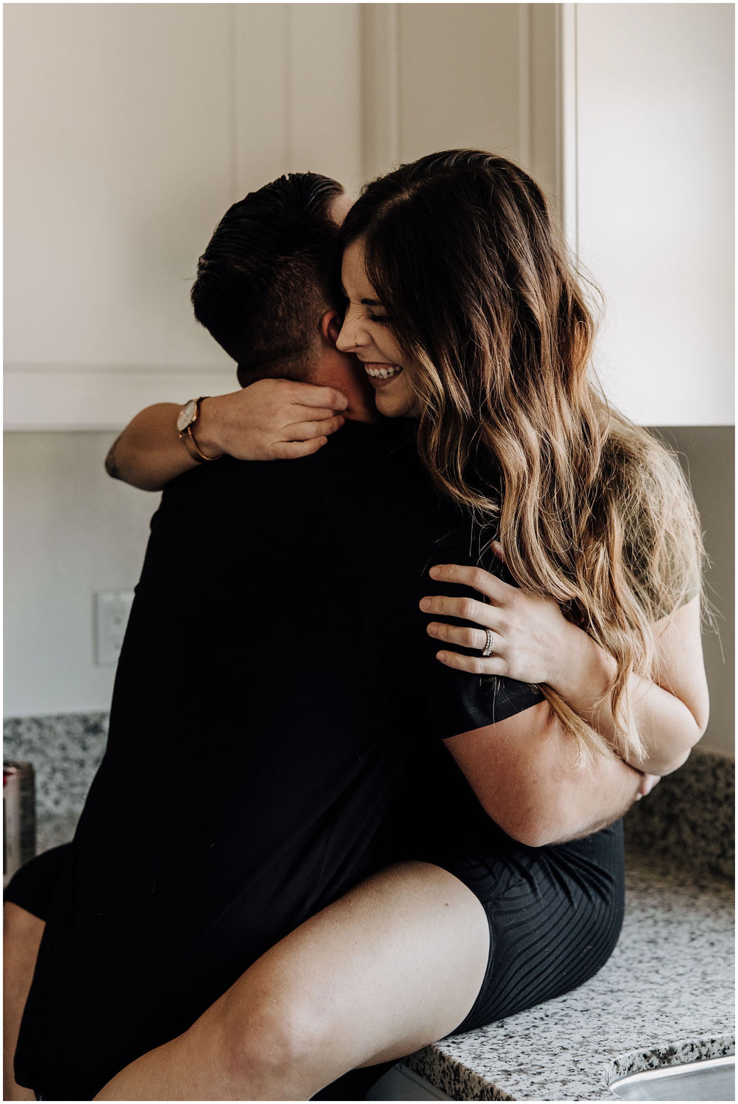 couple sitting on counter and hugging