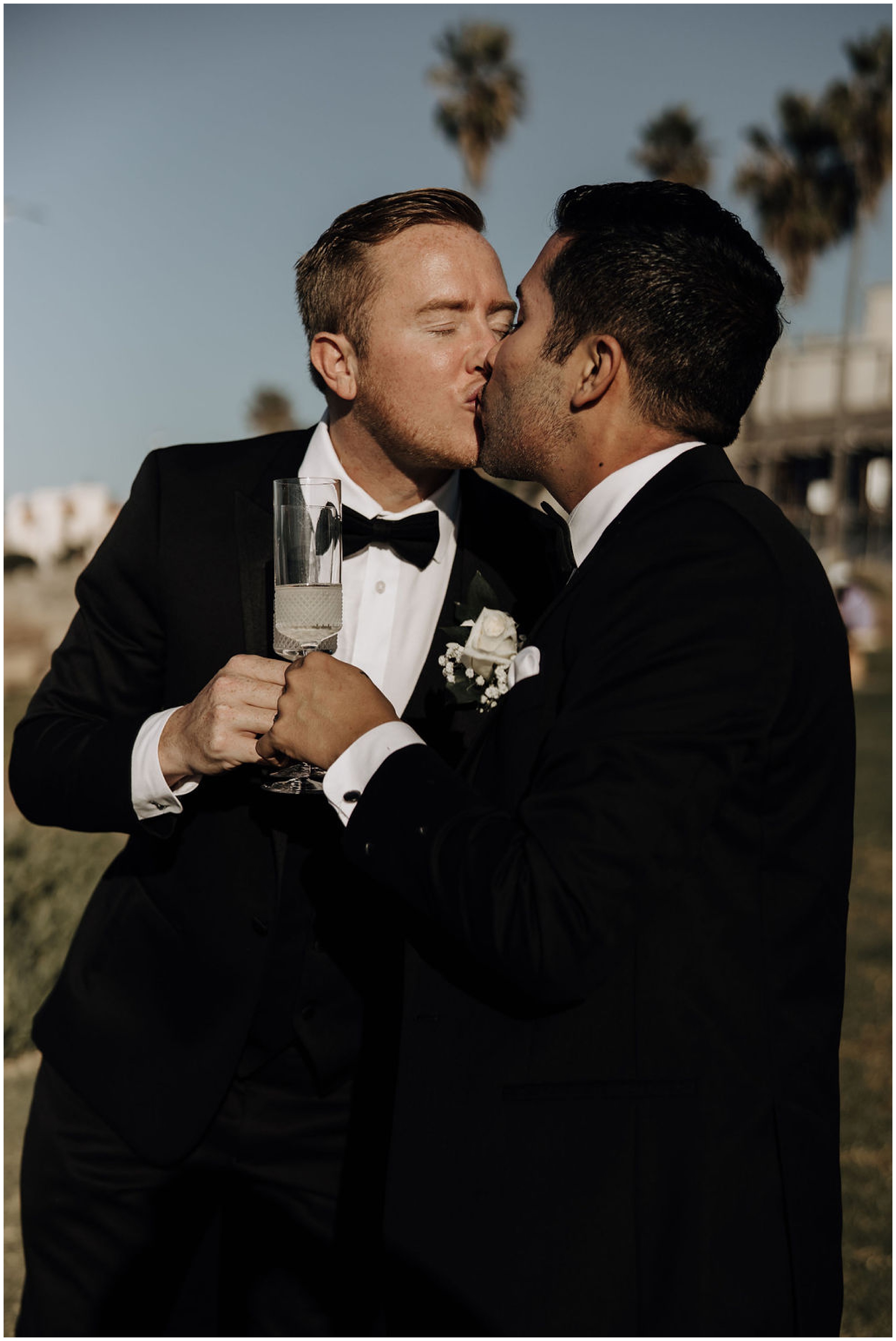 grooms kissing and drinking champagne
