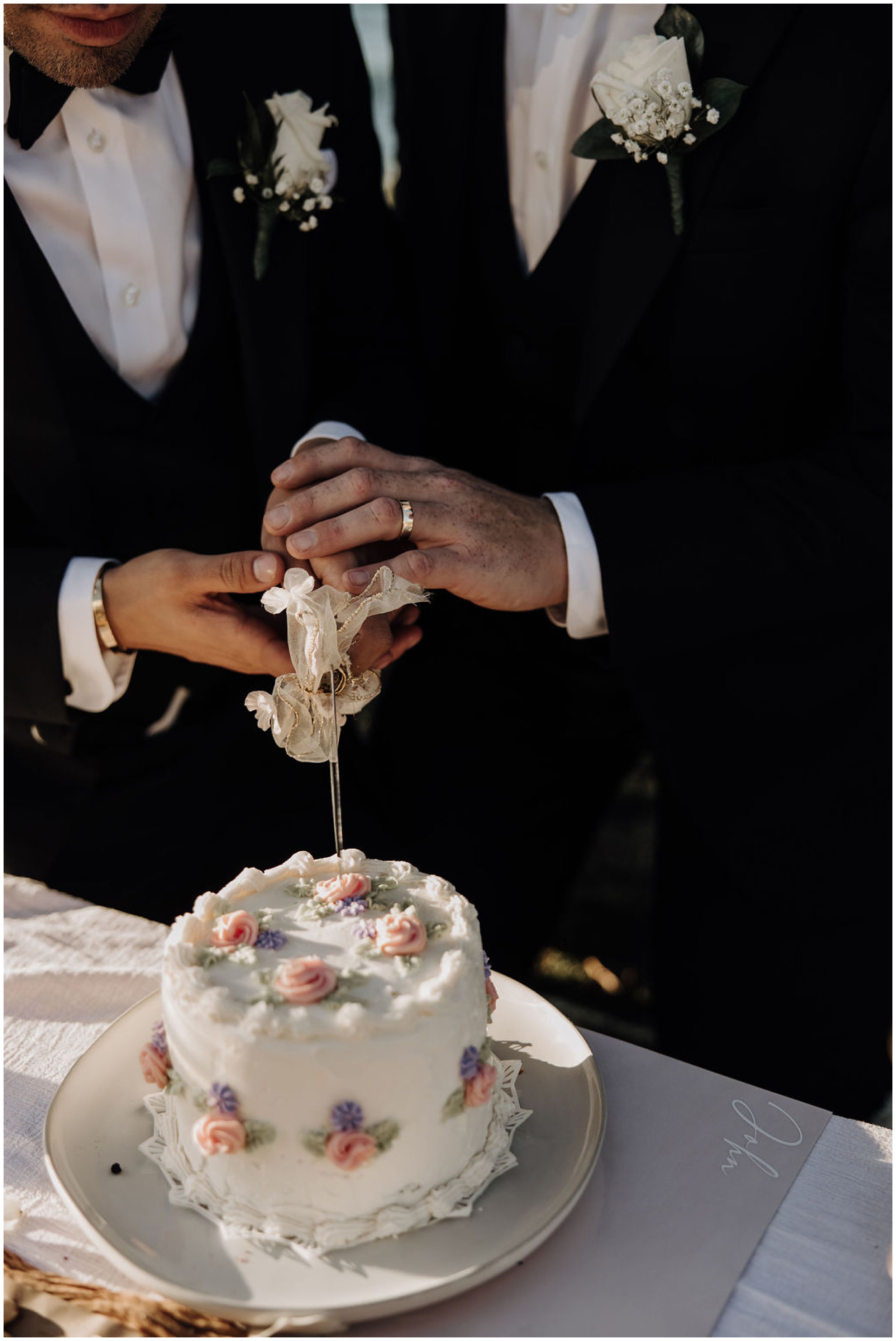 grooms cutting wedding cake