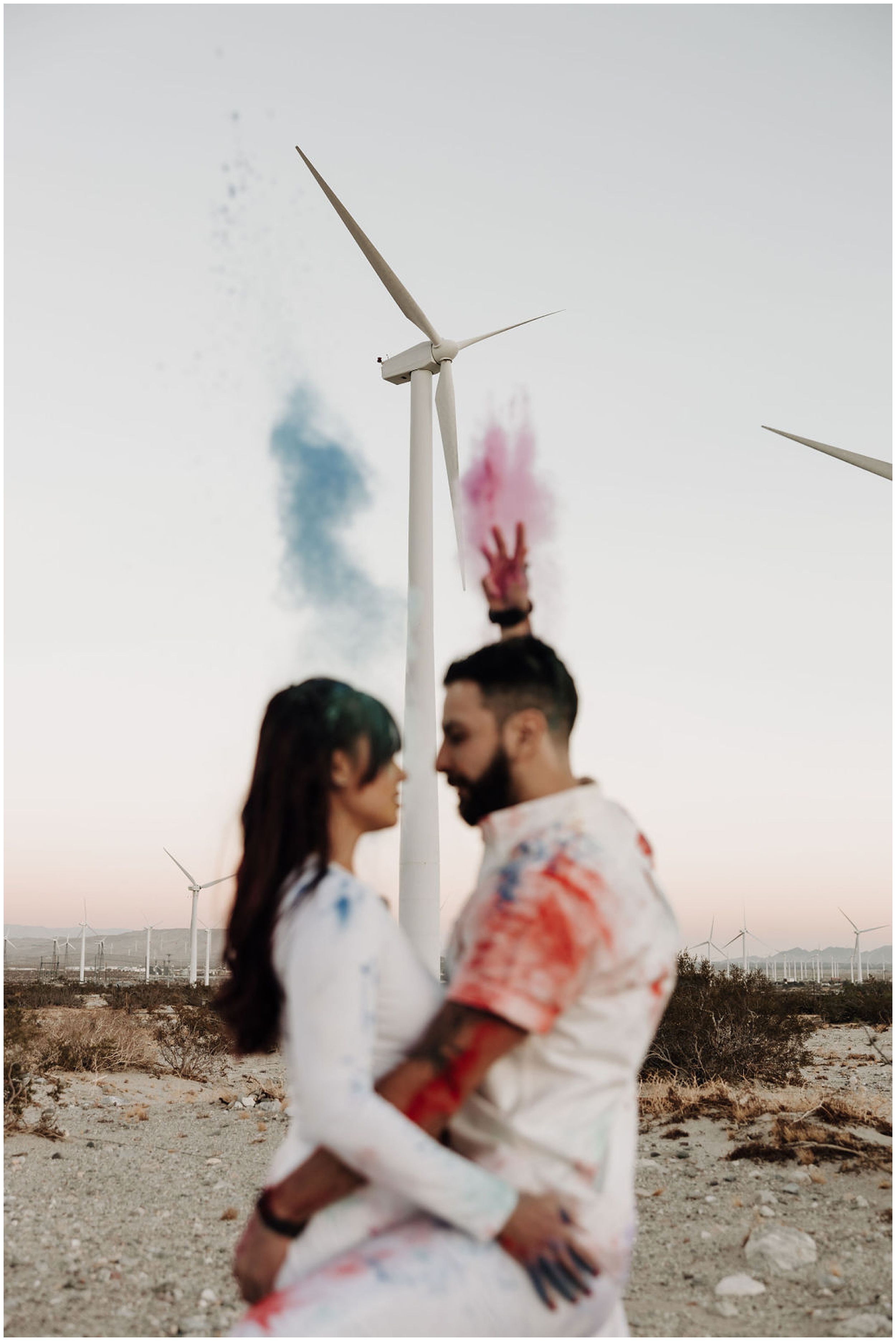 couple playing with colored powder for photos