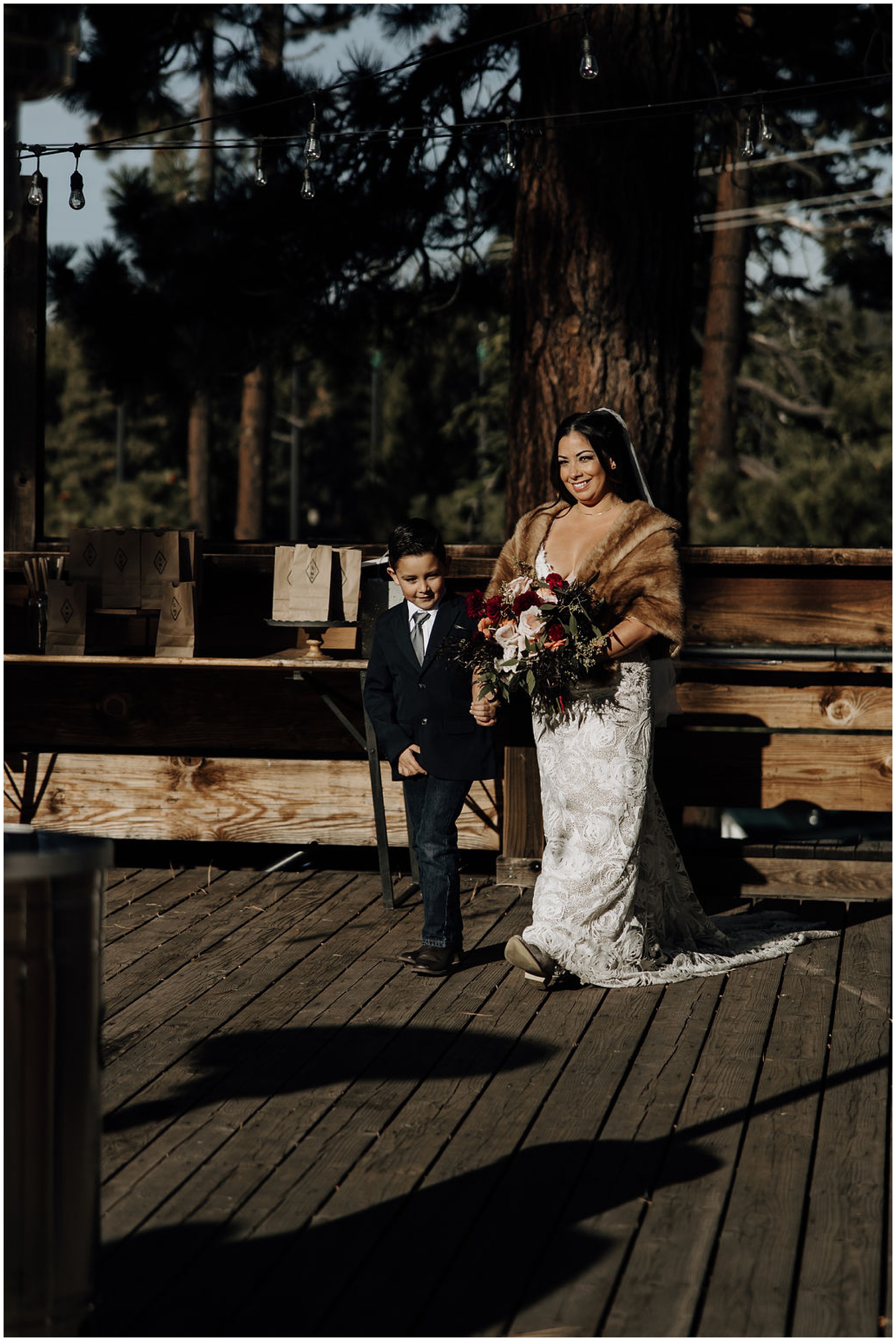 bride walking down the aisle with ring bearer